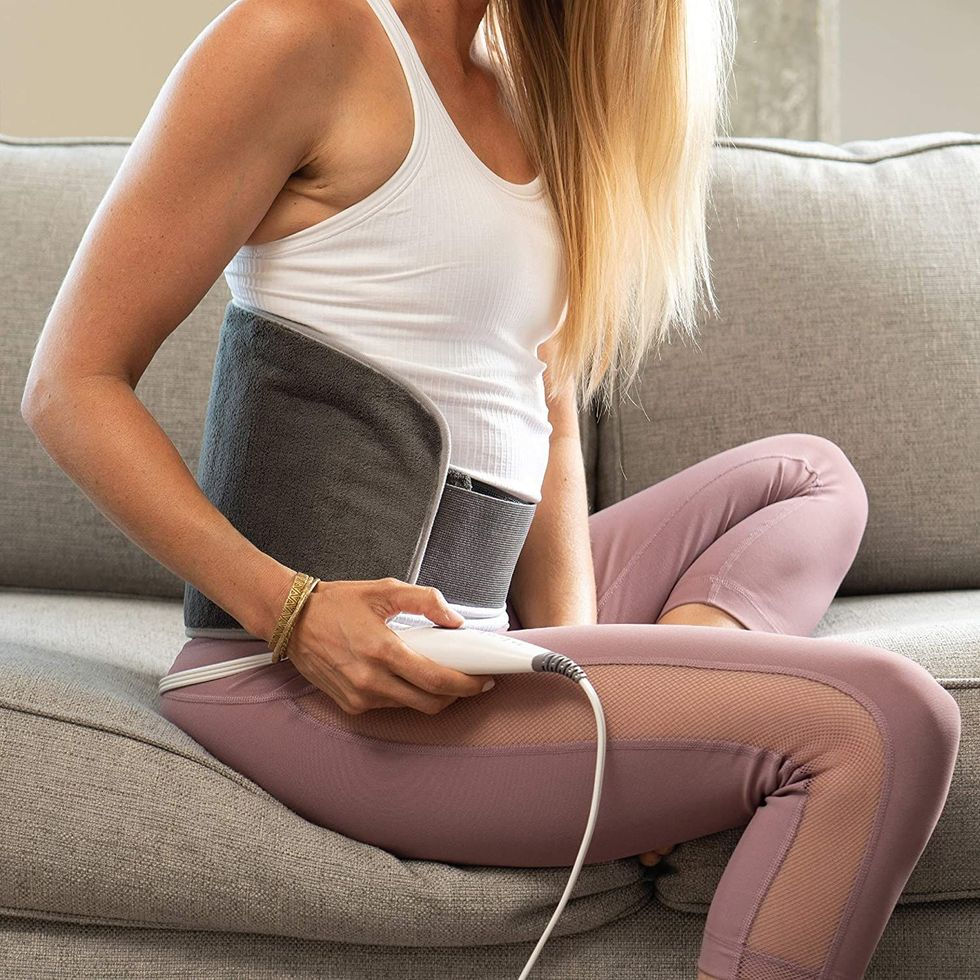 woman with heating bad wrapped around her waist