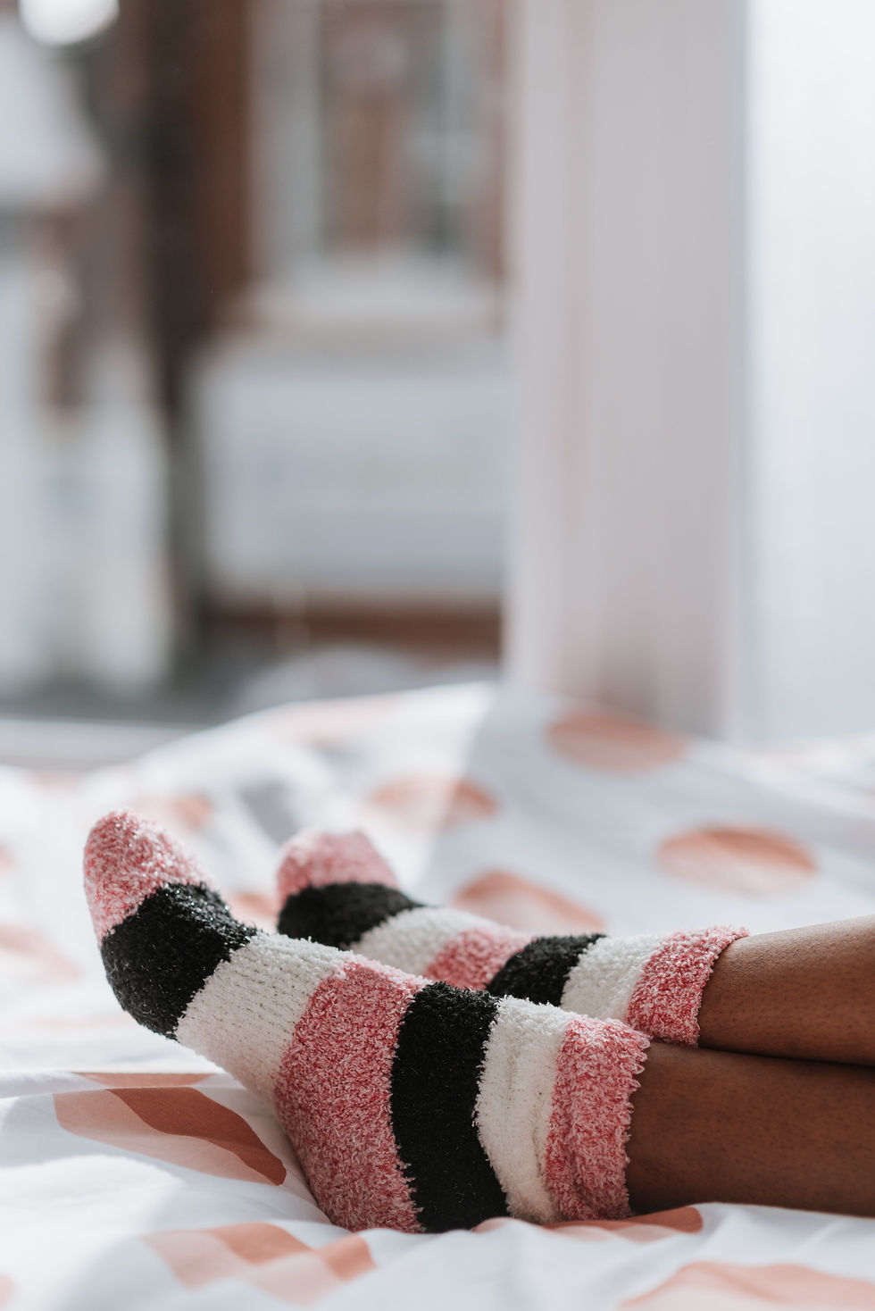 feet wearing striped fuzzy socks