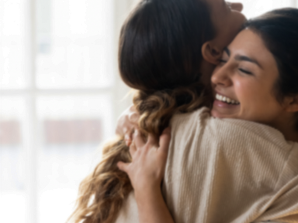 Two smiling women hugging
