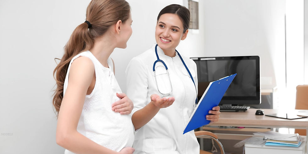 A doctor consults with a pregnant woman during a prenatal visit in a medical office (models)