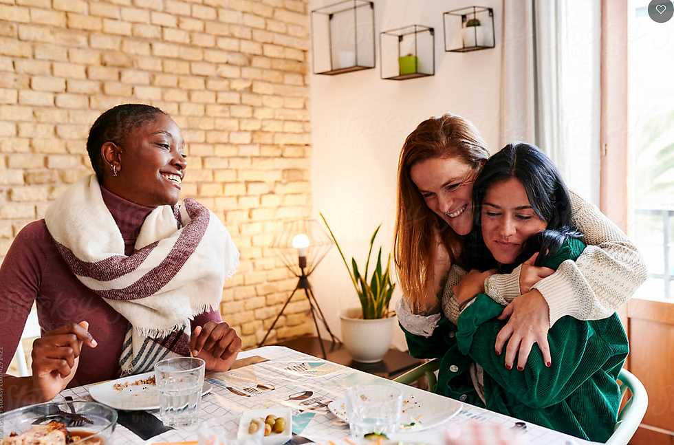 Two woman embrace a child