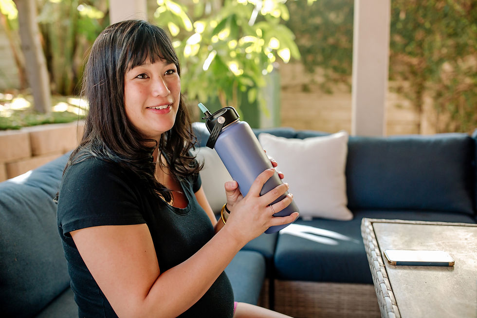 woman holding grey waterbottle