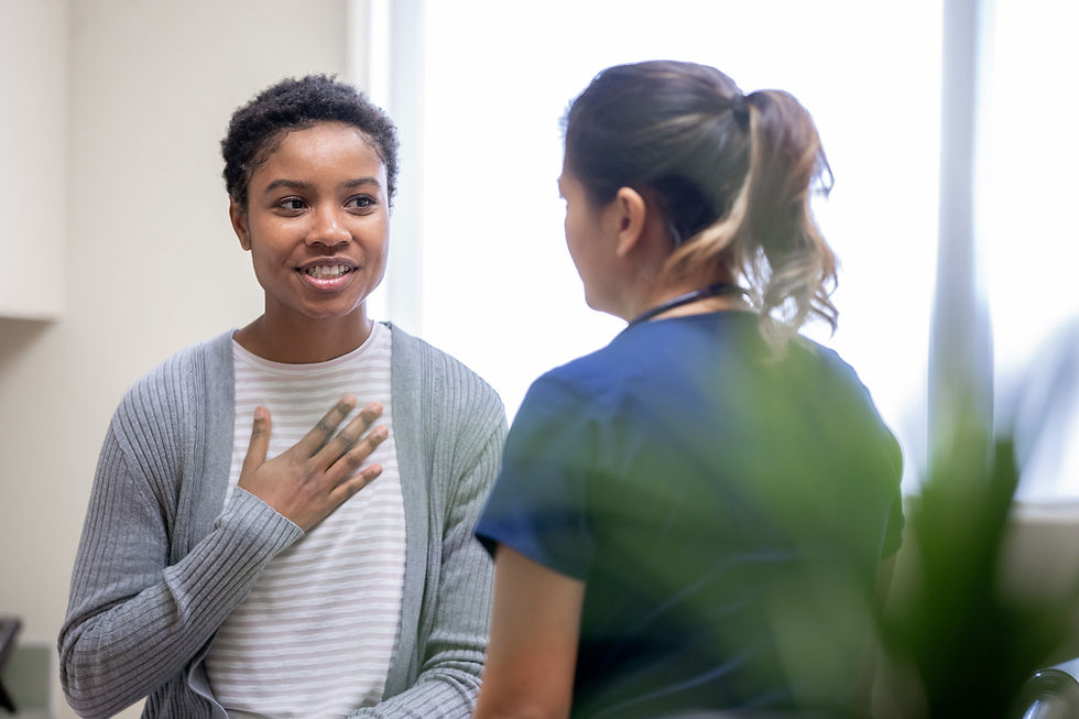 Woman in doctor's office talking to a medical professional