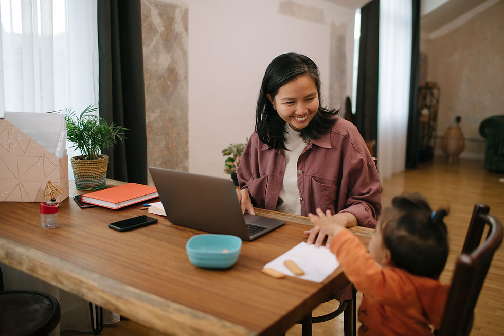 Smiling mother sitting at her desk with her child