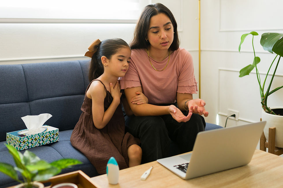 Mother and daughter looking at open laptop