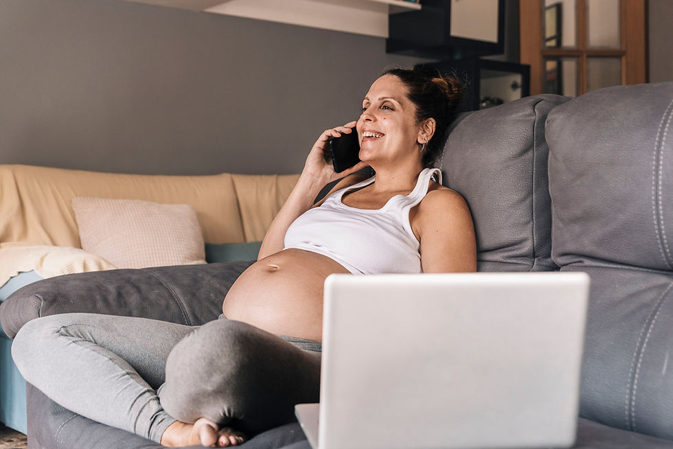 Smiling pregnant woman talking on the phone